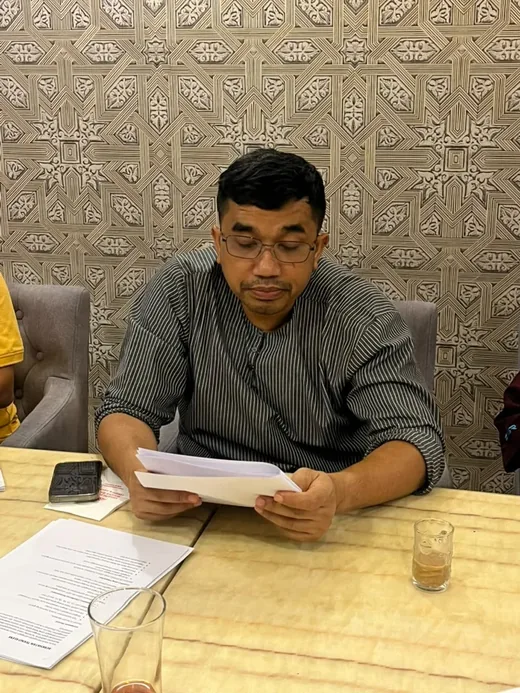 The chair reviewing working papers during the MADOCS committee meeting