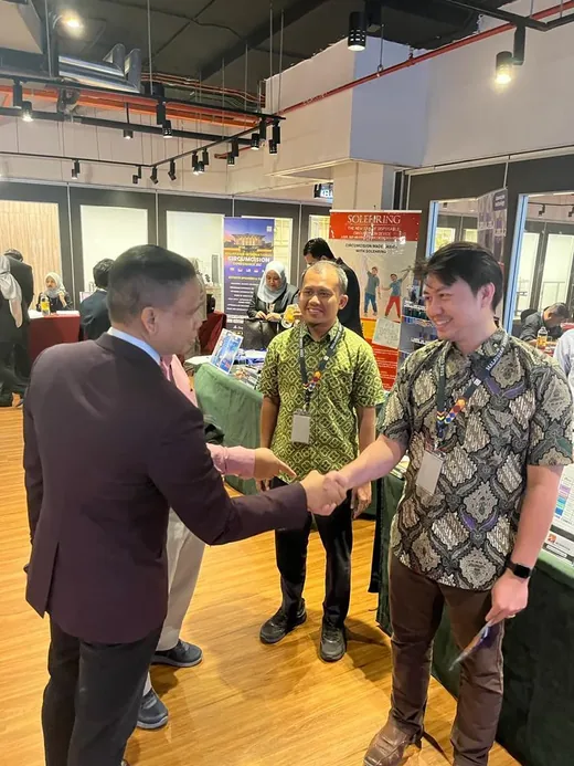 MADOCS President shaking hands with a partner NGO representative