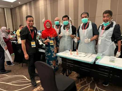 Circumcision trainers during a hands-on training session