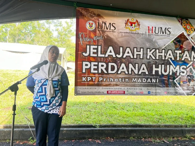Circumcision talk in front of a circumcision outreach programme banner